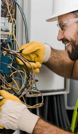 Electrician standing in front of a service van